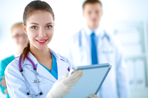 Attractive female doctor in front of medical group - Photo, image