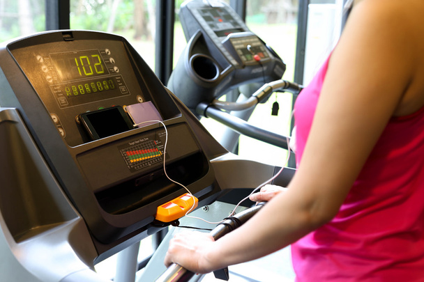 Woman exercise on the running machine at the gym - Photo, Image
