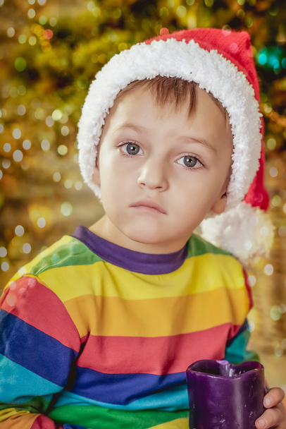 boy in a hat of Santa with a gift - Zdjęcie, obraz