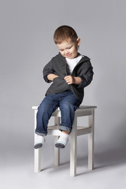funny child sitting oh the stool - Фото, изображение