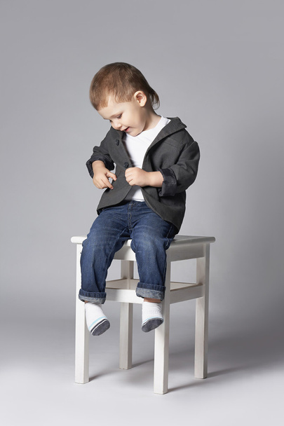 funny child sitting oh the stool - Foto, imagen