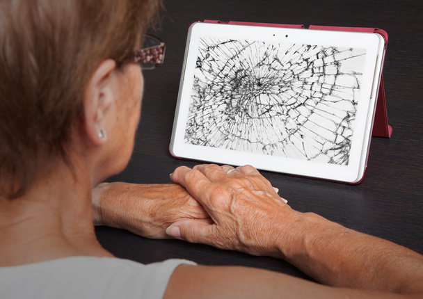 Senior lady with tablet, cracked screen - Photo, Image