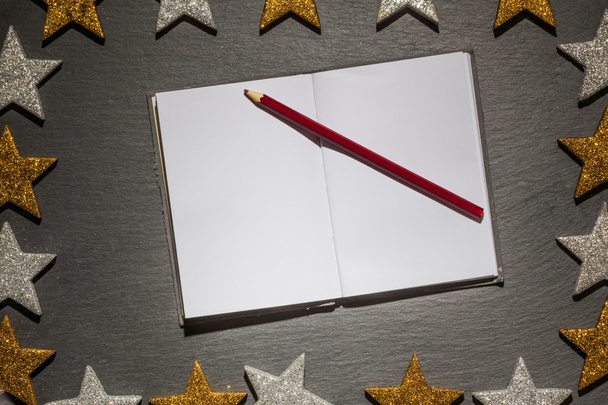 Notepad with red pencil on slate background, christmas frame - Photo, Image