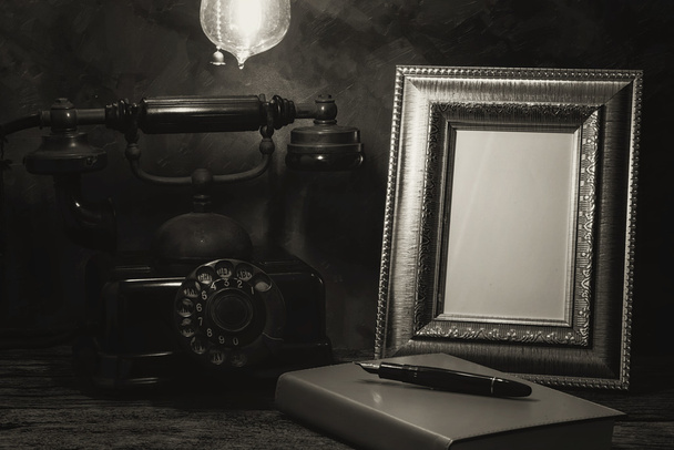 Still life of vintage telephone with picture frame and diary on  - Fotó, kép