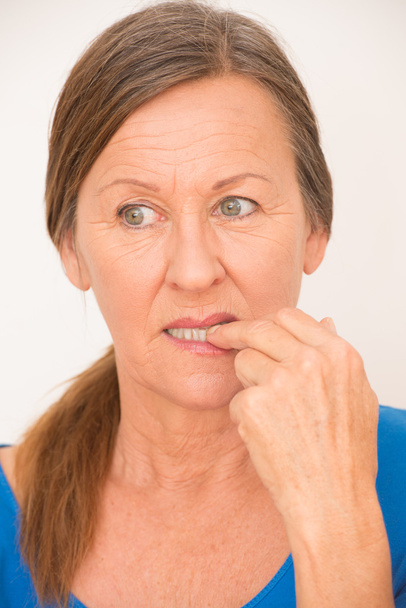 Nervous woman biting finger - Foto, Imagen