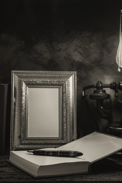 Still life of vintage telephone with picture frame and diary on  - 写真・画像