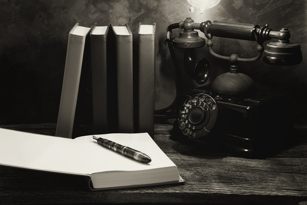 Still life of vintage telephone on table with diary book - Fotoğraf, Görsel