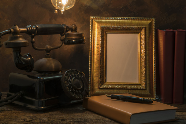 Still life of vintage telephone with picture frame and diary on  - Foto, afbeelding