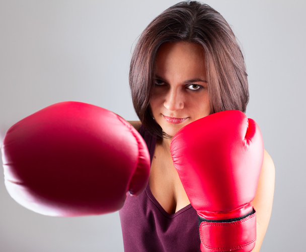 sexy girl woman athlet in red boxing gloves kicking - Foto, imagen