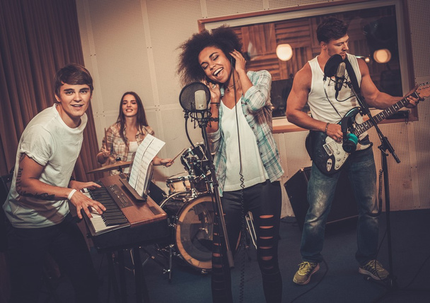 Multiracial music band performing in studio - Photo, Image