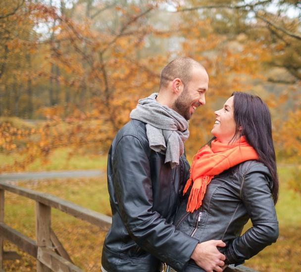 Happy middle-aged couple outdoors on beautiful autumn day - Photo, Image