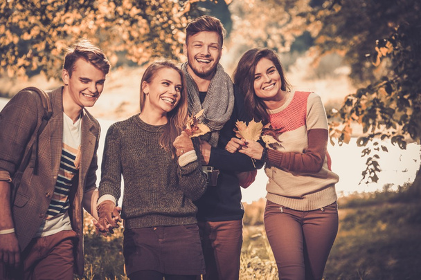 Cheerful friends in autumn park - Photo, Image