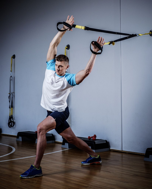man during workout with suspension straps - Photo, Image