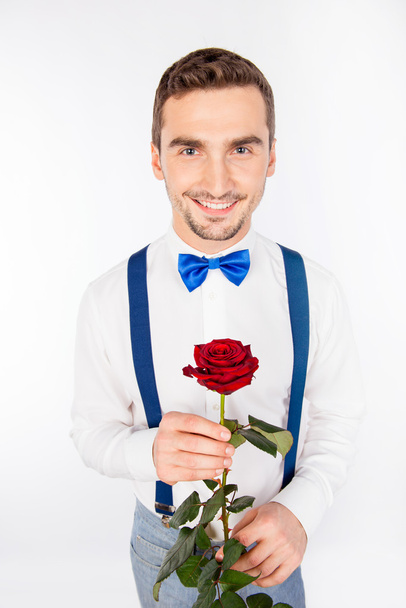 Handsome young man with nice red rose - Φωτογραφία, εικόνα