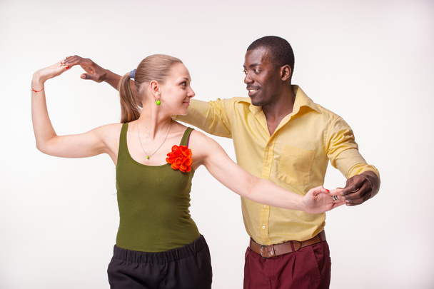 Young couple dances Caribbean Salsa, studio shot - Foto, afbeelding