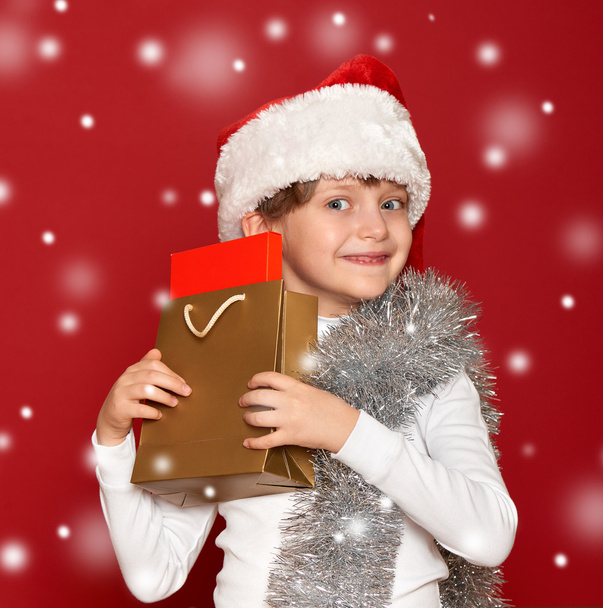 winter, child,  christmas concept - happy girl in santa hat with - Zdjęcie, obraz