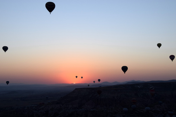 Balloon flying over Cappadocia, Turkey at sunrise - Фото, изображение