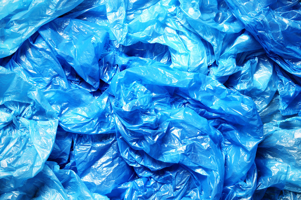 A lot of crumpled blue plastic bags - Фото, зображення