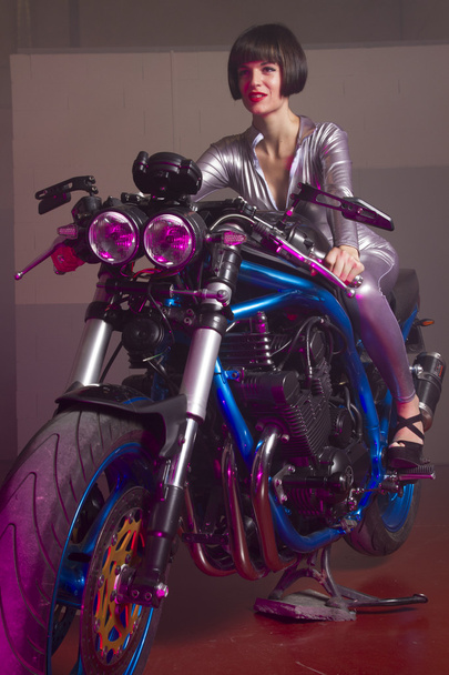 brunette in  latex suit on a bike  - Fotó, kép