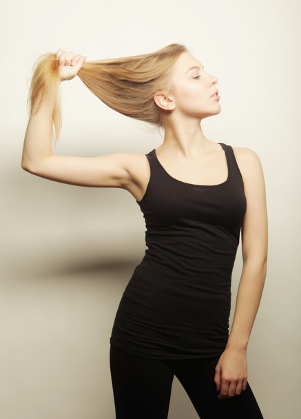 Beautiful woman with long blond hair. Fashion model posing at st - Fotografie, Obrázek
