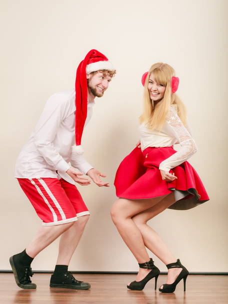 Smiling couple in santa claus hat. Christmas. - 写真・画像