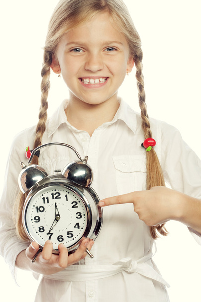 little girl with a silvered alarm-clock a isolated on a over wh - Fotoğraf, Görsel