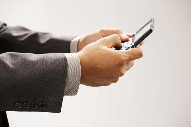 Man holding a handphonesending text messages - Photo, image
