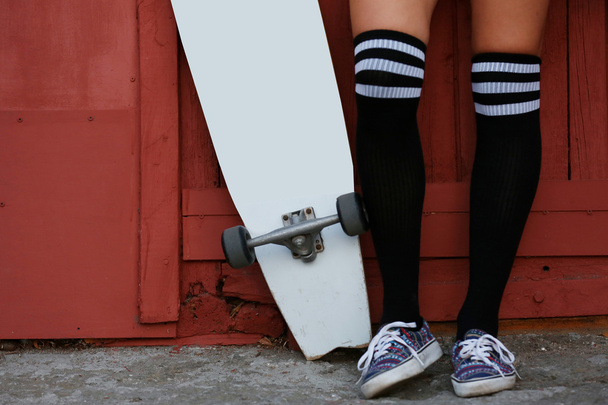Young woman with skating board  - Foto, Imagen