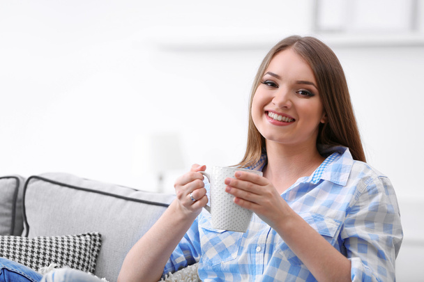 young woman drinking tea at home - Fotoğraf, Görsel