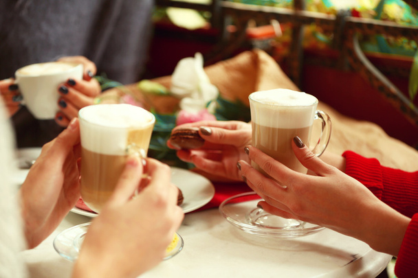 Women meeting in cafe and drinking latte - Фото, зображення