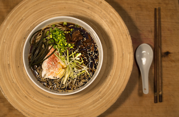 Soupe de nouilles ramen japonaise dans un bol blanc sur une table en bois
 - Photo, image