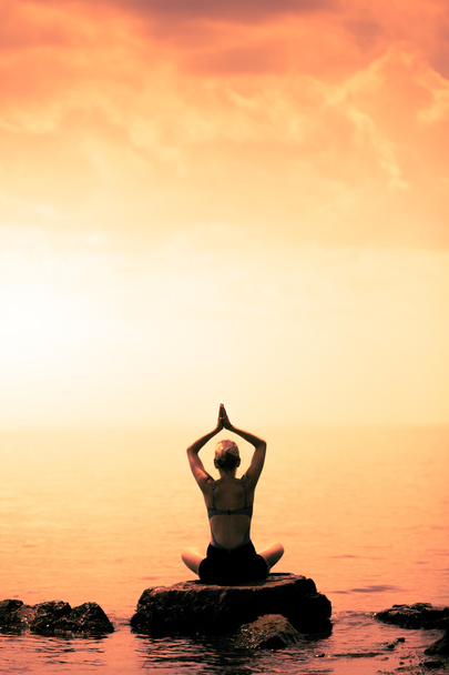 Woman doing Lotus Yoga Position - Фото, изображение