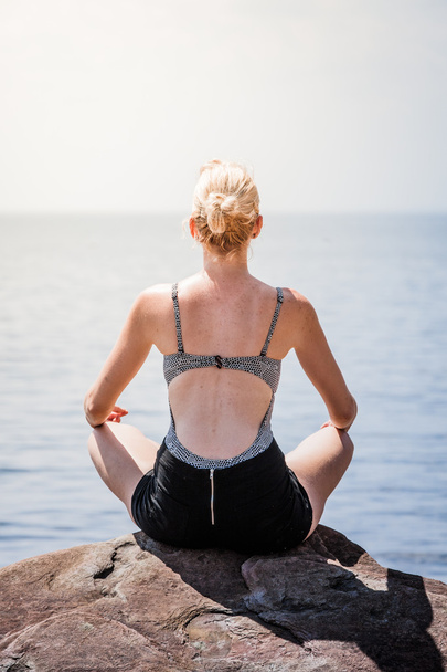 Woman doing Lotus Yoga Position - 写真・画像