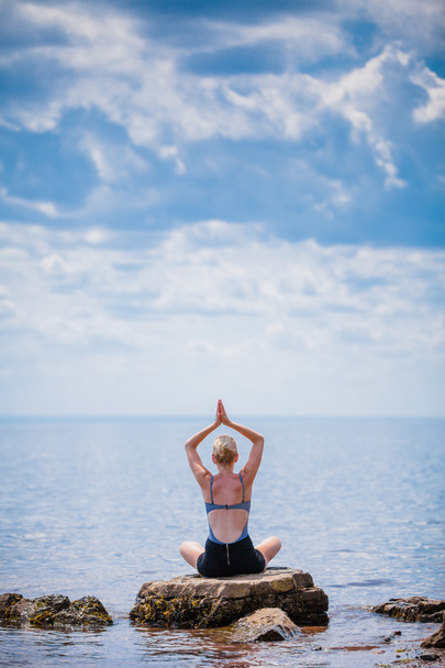 Woman doing Lotus Yoga Position - Foto, afbeelding