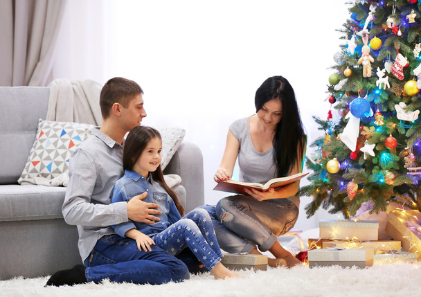 Happy family read book in the decorated Christmas room - Foto, immagini
