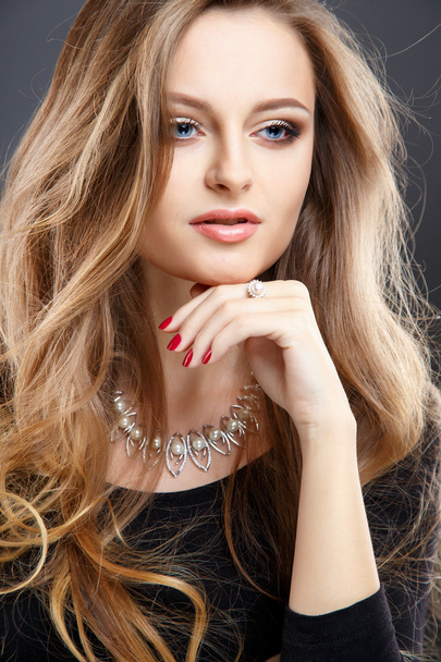Close-up portrait of beautiful young woman with luxury jewelry and perfect make up. Fashion beauty portrait - Фото, изображение
