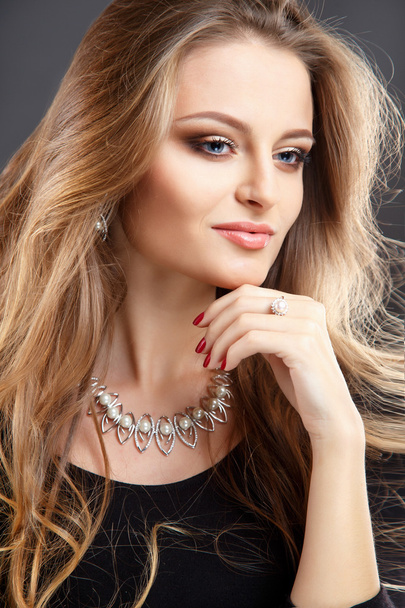 Close-up portrait of beautiful young woman with luxury jewelry and perfect make up. Fashion beauty portrait - Фото, изображение