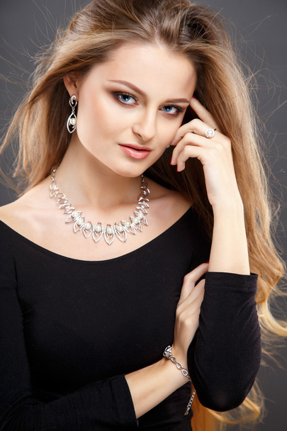 Close-up portrait of beautiful young woman with luxury jewelry and perfect make up. Fashion beauty portrait - Photo, Image