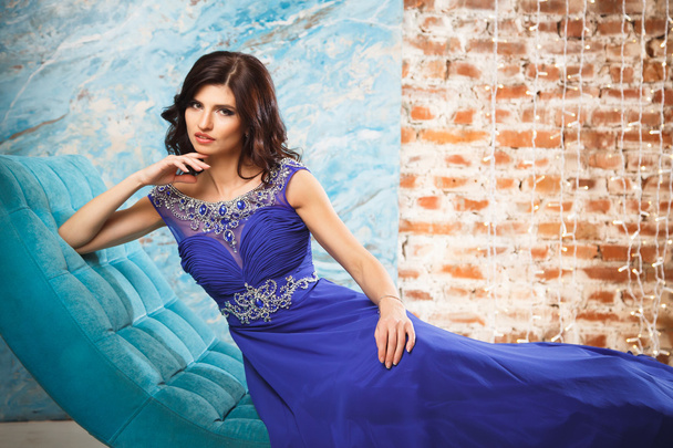 Portrait of gorgeous brunette woman in luxury blue dress with perfect make up and hair style - Photo, image