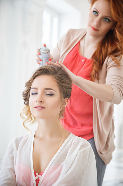 Hair Stylist preparing beautiful bride before the wedding in a morning - Photo, Image