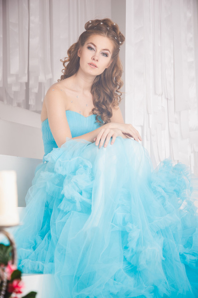Beautiful young woman in gorgeous blue long dress like Cinderella with perfect make-up and hair style - Φωτογραφία, εικόνα