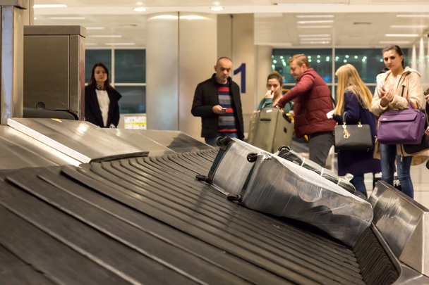 Luggage Belt at Airport Terminal with Bags and Passengers - 写真・画像