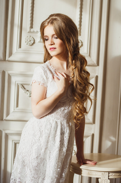 Portrait of pretty young girl in a white dress and long blonde hair - 写真・画像