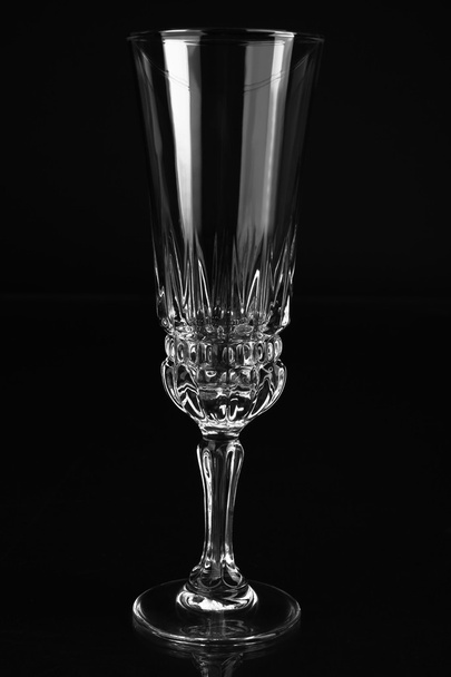 Empty champagne glass on black background - Foto, afbeelding
