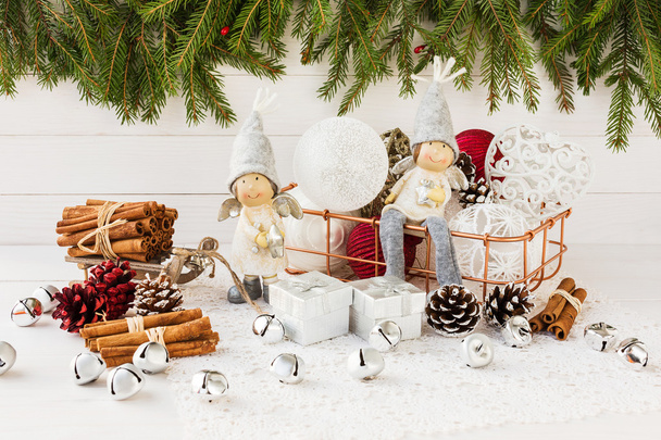 Christmas angels and Christmas balls in basket, Christmas tree on white wooden background - Foto, afbeelding