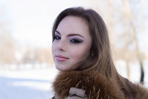 Attractive girl on winter embankment. - Photo, Image