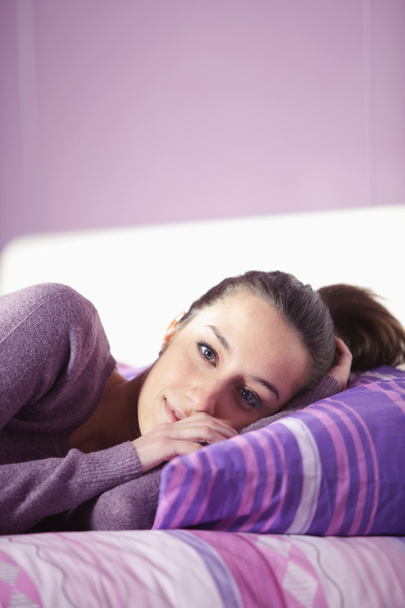 Gros plan d'une jeune femme couchée sur le lit
 - Photo, image
