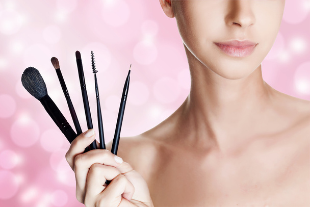 Portrait of beautiful woman with brushes for make-up - Фото, зображення