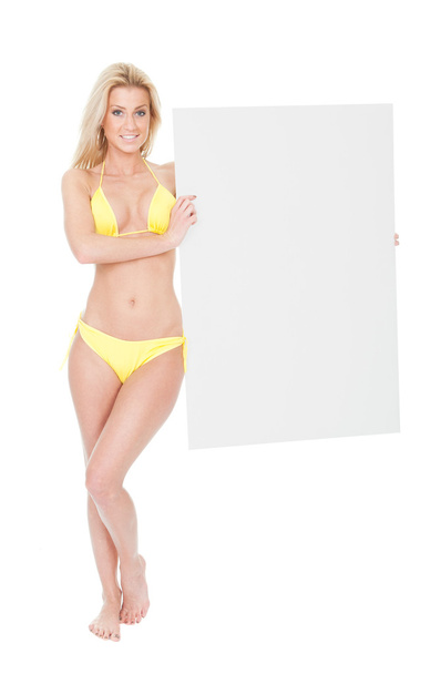 Woman in bikini presenting empty board - 写真・画像