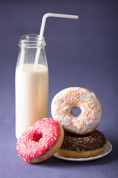 Donut with milk at violet background - Foto, imagen